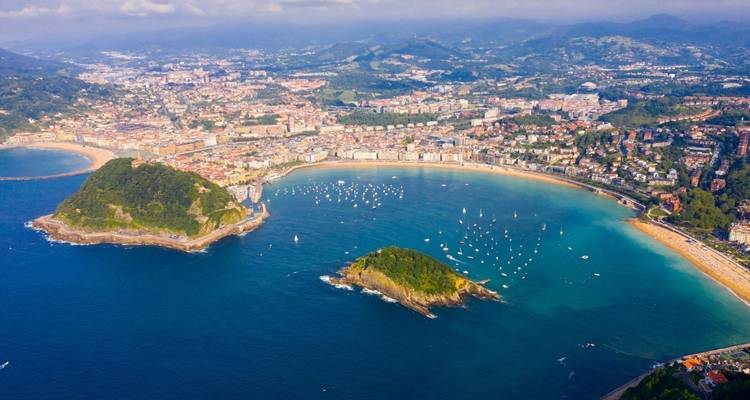 Spectacular aerial view of San Sebastián’s La Concha Bay with city, beaches and green hills