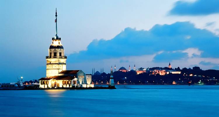 Maiden's Tower in Istanbul lit up against the evening sky.