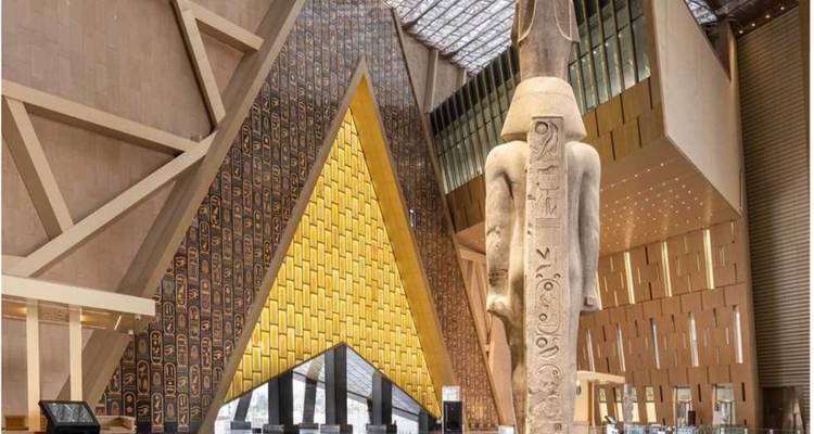 Interior of modern museum with large ancient statue.