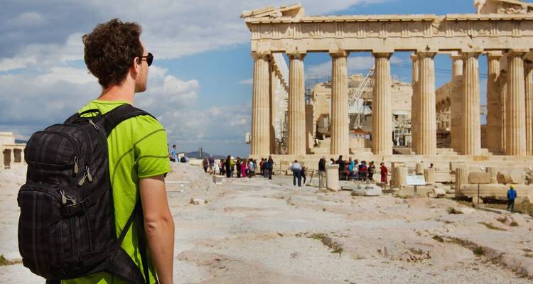 Man with backpack admiring the Parthenon in Athens, Greece.