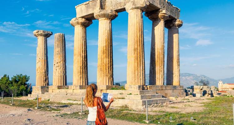 Woman looking at the Temple of Apollo in Greece.
