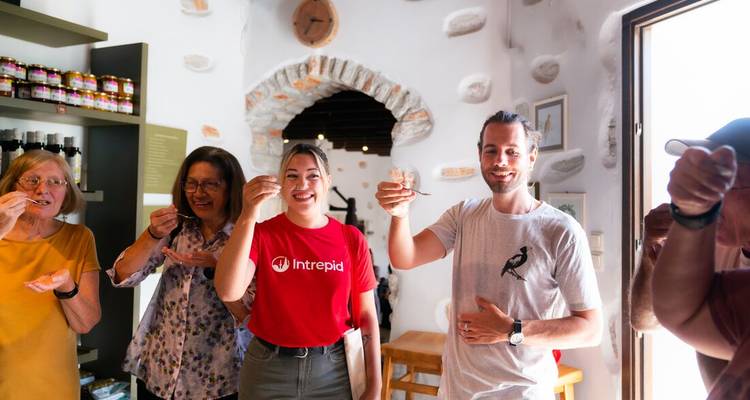 Group of people tasting samples inside a traditional store.