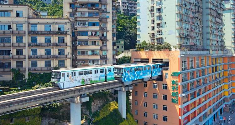 Train passing through a building in the city.