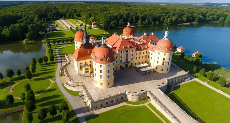 Aerial view of Moritzburg Castle surrounded by water.