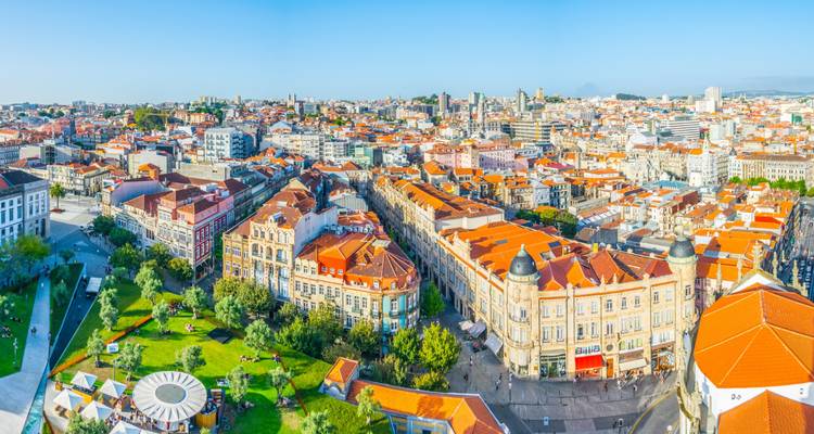 Panoramic cityscape with historic buildings and green spaces.