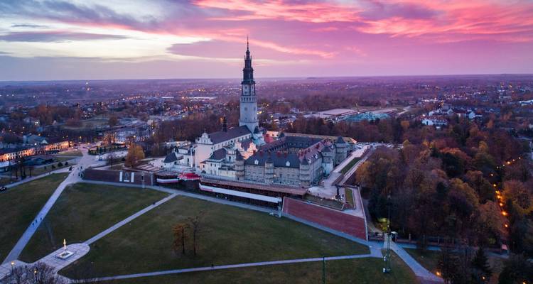 Historic religious site with expansive open grounds during sunset.
