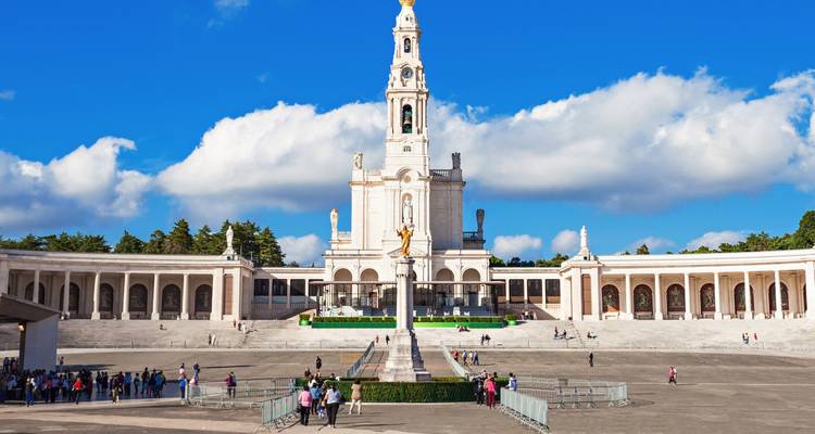 Fatima Sanctuary with visitors in front of the grand structure.
