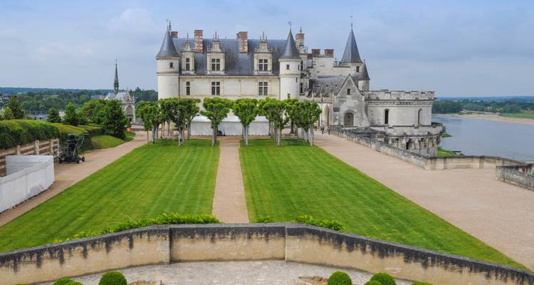 Chateau with symmetrical lawns and tall turrets.