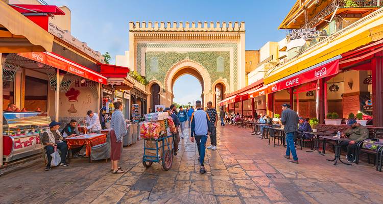 People walking in a bustling market square.