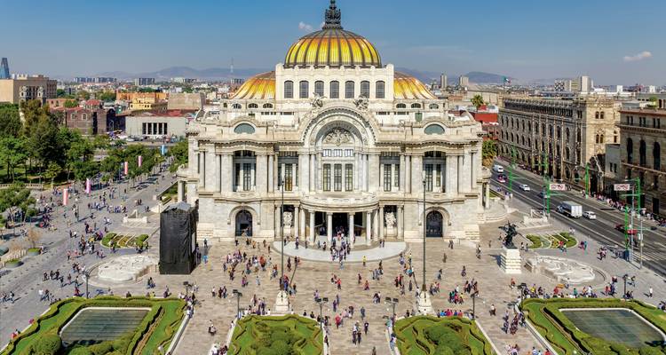 Palace of Fine Arts in Mexico City with surrounding gardens.