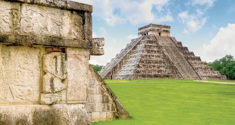 Mayan pyramid of Chichen Itza under a clear blue sky.