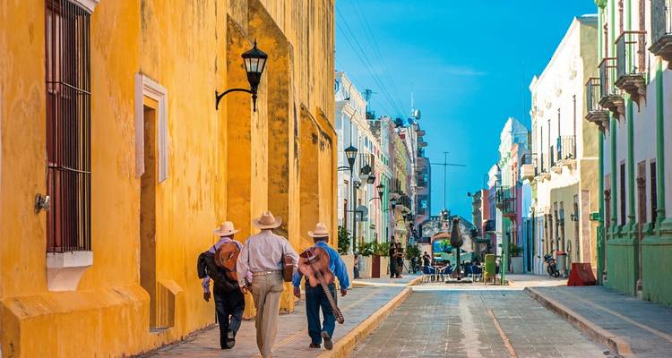 Vibrant street view with colonial architecture and people walking.