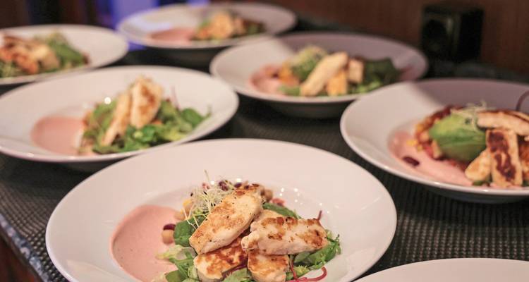 Multiple plates of well-presented food dishes.