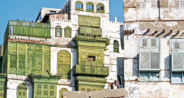 Historical buildings with green wooden shutters.