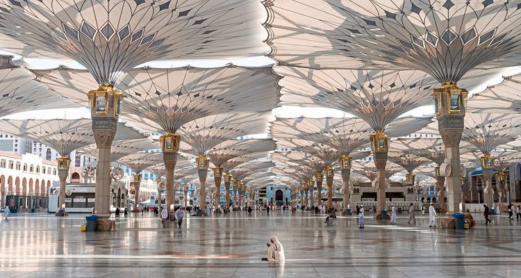 Expansive courtyard with large umbrellas in Medina, Saudi Arabia.
