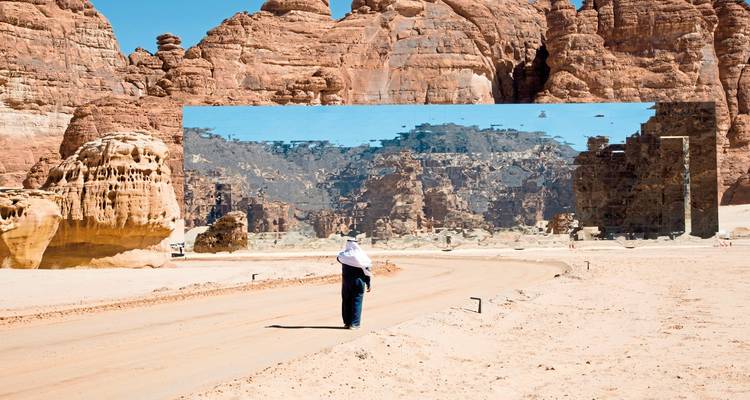 Person in front of a mirrored building in the desert.