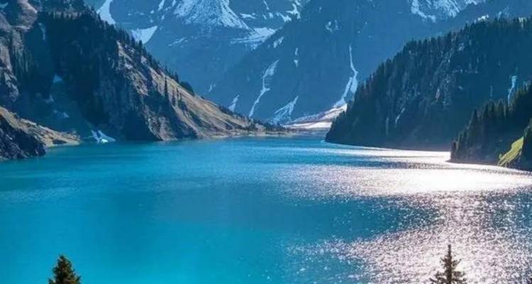 Stunning blue lake surrounded by mountains and lush forests.