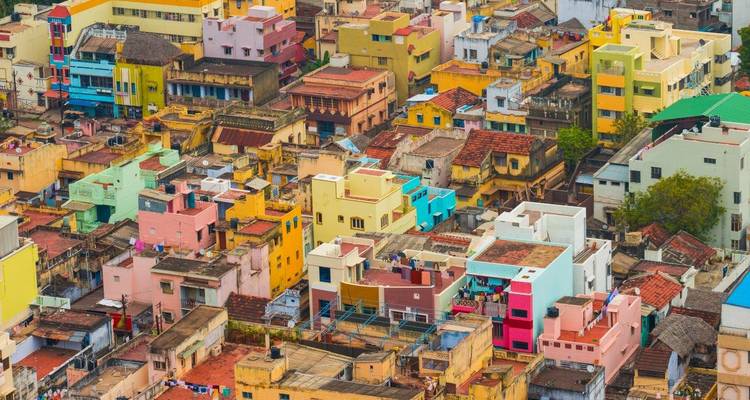 Aerial view of colorful buildings stacked in a densely populated area.