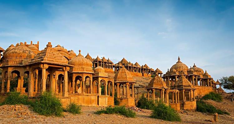 An array of intricately carved cenotaphs set against a desert landscape.