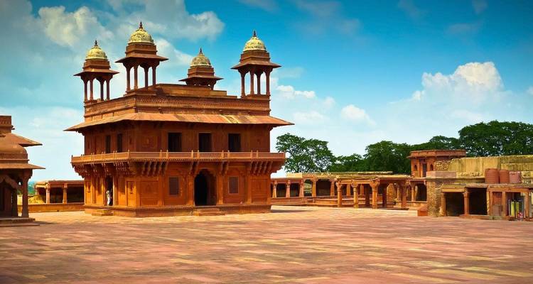 A historic pavilion surrounded by a vast empty courtyard in Fatehpur Sikri.