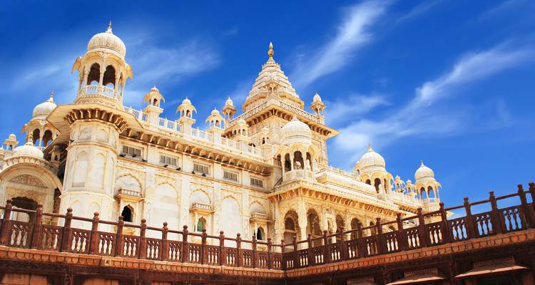 A grand palace facade with domes and intricate architectural details.