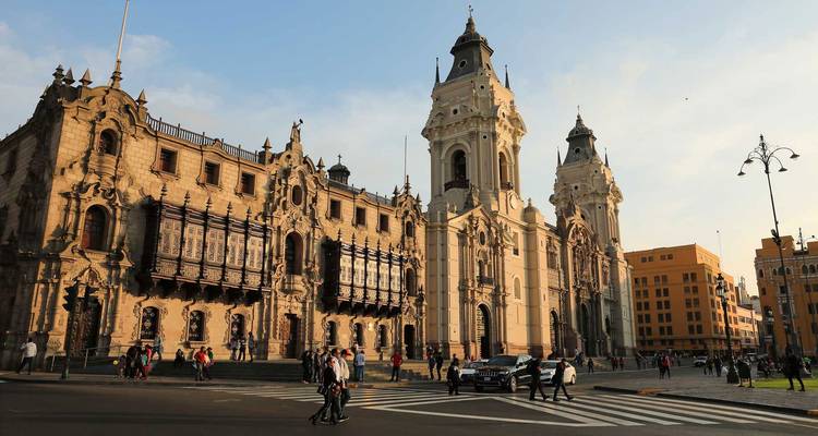 Historic buildings and cathedral in a bustling city square.