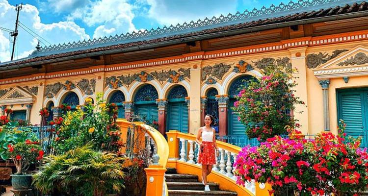Tourist visiting a colorful colonial building with ornate architecture.
