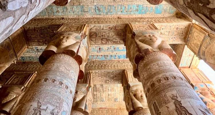 Egyptian temple ceiling with colorful hieroglyphics.