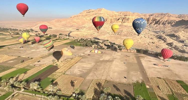 Hot air balloons over an Egyptian landscape.
