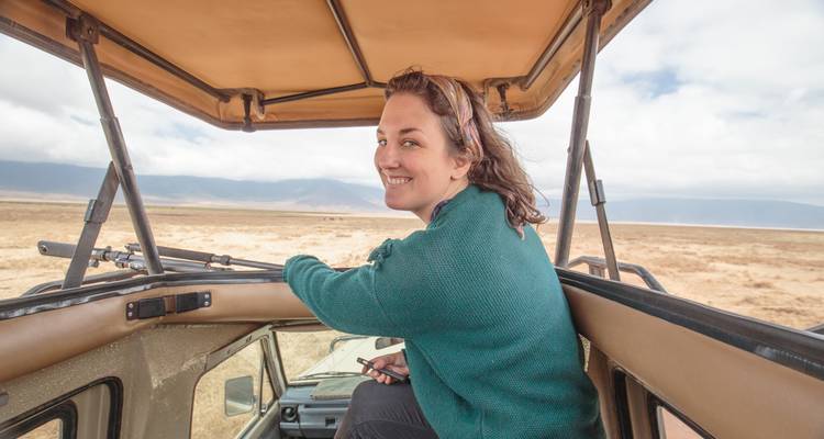 Person smiling from the top of an open safari vehicle.