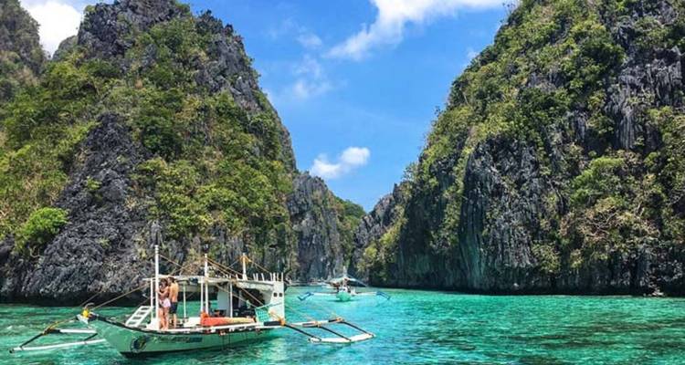 Traditional boats navigating through a crystal clear lagoon.