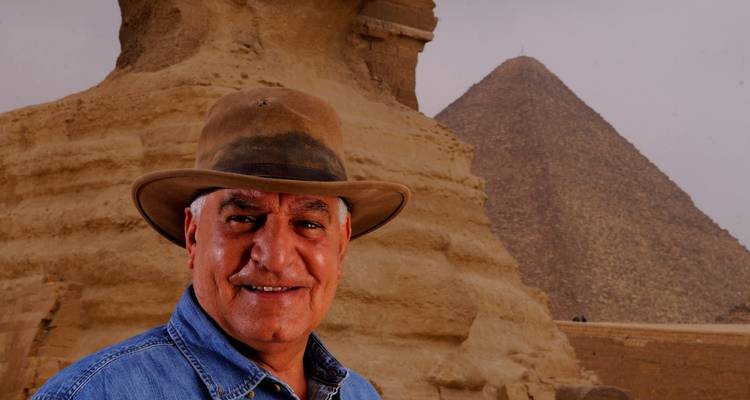 Portrait of a man with the Sphinx and pyramid in the background.