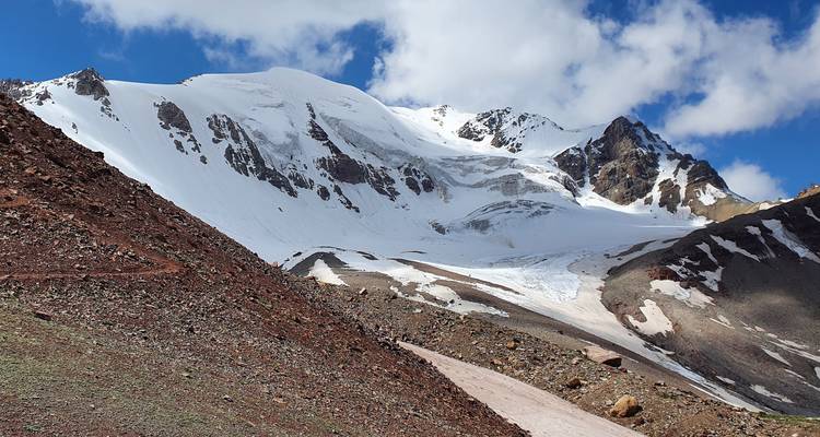 Snow-covered mountain range with rocky path