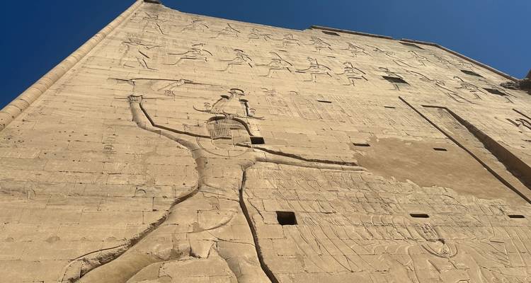 Grote stenen beeldhouwwerk van een oude Egyptische figuur.