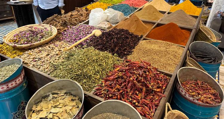 Colorful spices displayed in a market stall.