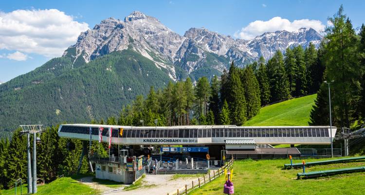 Kreuzjochbahn station with stunning mountain views.