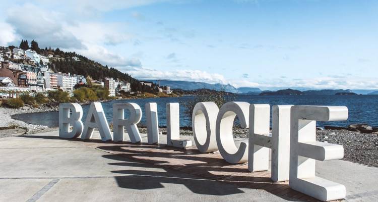 The Bariloche sign with a lake and mountains in the background.