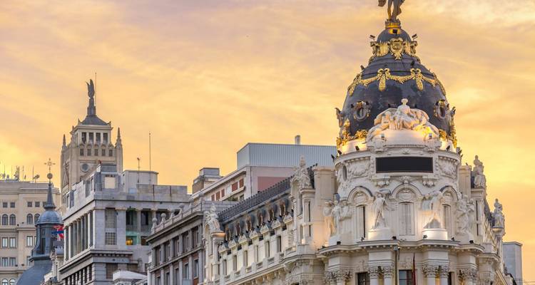 Historic building with eclectically ornate dome at sunset.