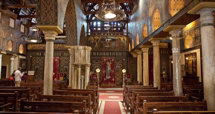 Interior of a church with columns and ornate woodwork.