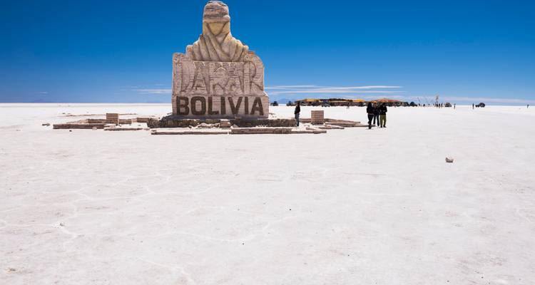 Stone monument with the word 'Bolivia' on the Uyuni Salt Flats.