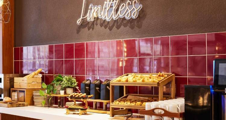 Buffet with pastries under a 'Limitless' sign.