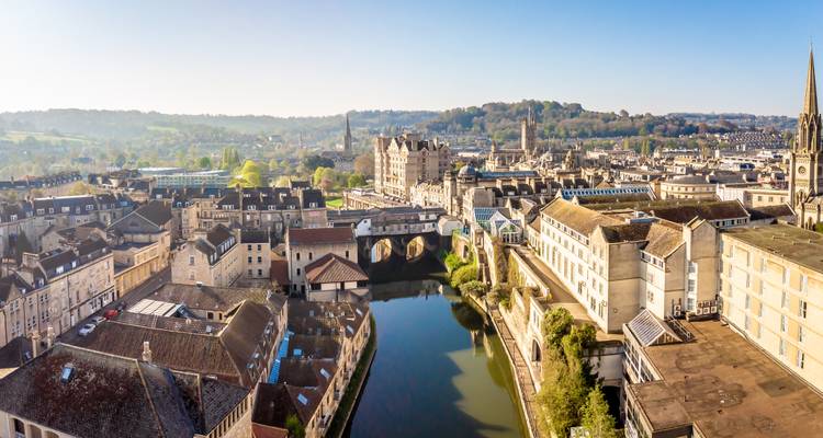 Aerial view of Bath with historic buildings along a river.