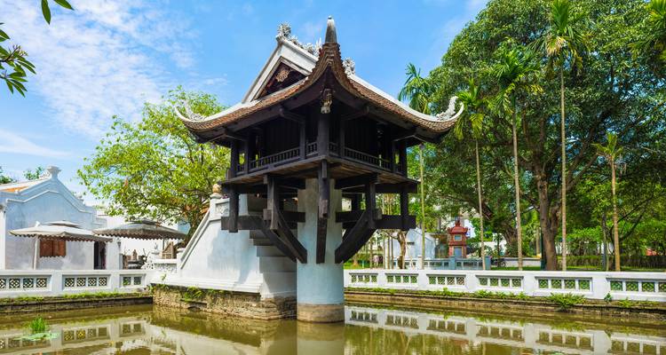 Close-up view of Hanoi’s One Pillar Pagoda reflected in its surrounding pond on a sunny day.