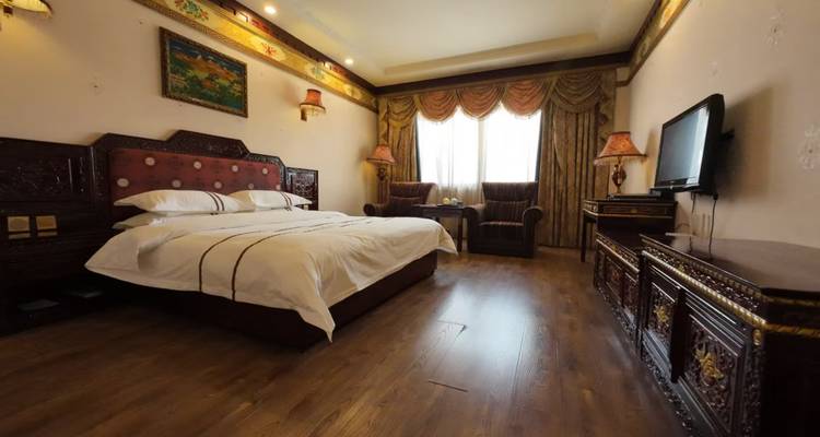 Gemütliches Hotelzimmer mit geschnitztem Holzkopfteil, warmer Beleuchtung und traditionellen Stoffen.