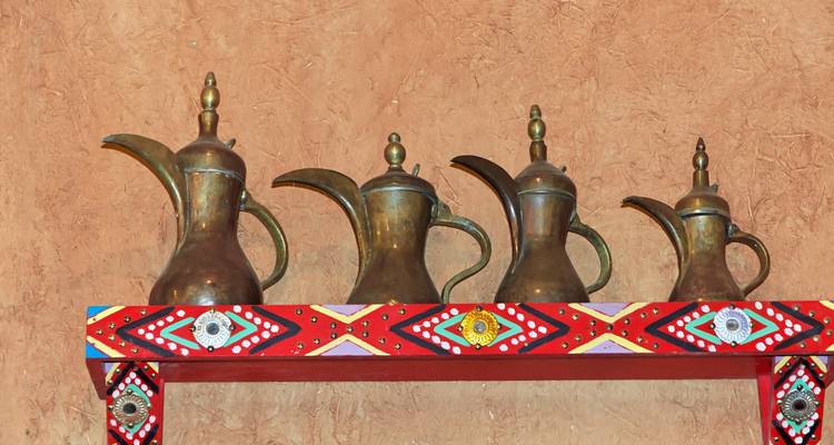 Traditional decorative pots displayed on a colorful shelf.