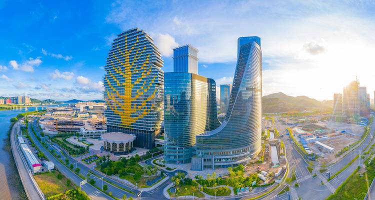 Modern buildings with unique architecture at sunrise.
