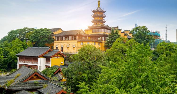 Traditional Chinese architectural complex amidst greenery.