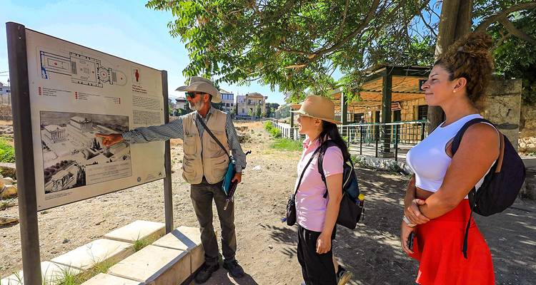 Tour guide explaining a site to a group of tourists.