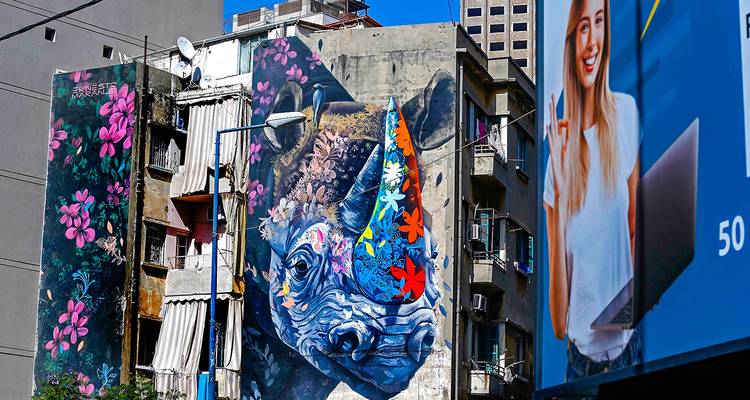 Building with colorful urban art on wall.