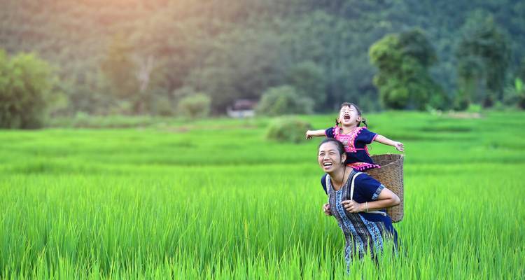 Mother and child in traditional attire in a field